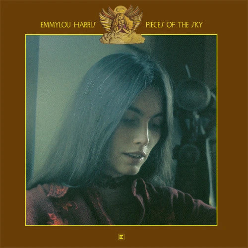 Album cover for 'Piece of the Sky' by Emmylou Harris, featuring a portrait of the artist in a vintage studio setting with a warm brown border and gold text and emblem.