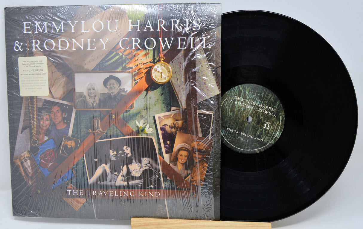 Vinyl record with cover featuring Emmylou Harris and Rodney Crowell's 'The Traveling Kind' on a white background.