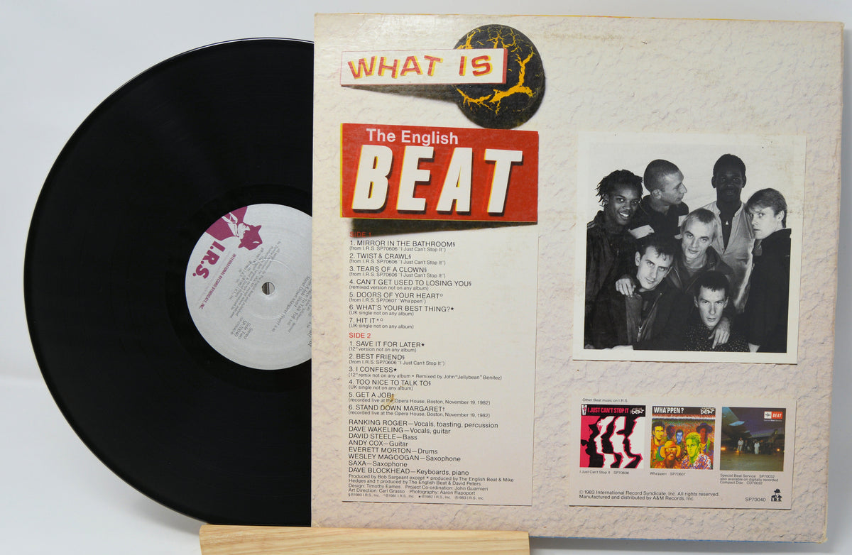 Vinyl record with its cover displaying text and images, including a black and white photo of people.