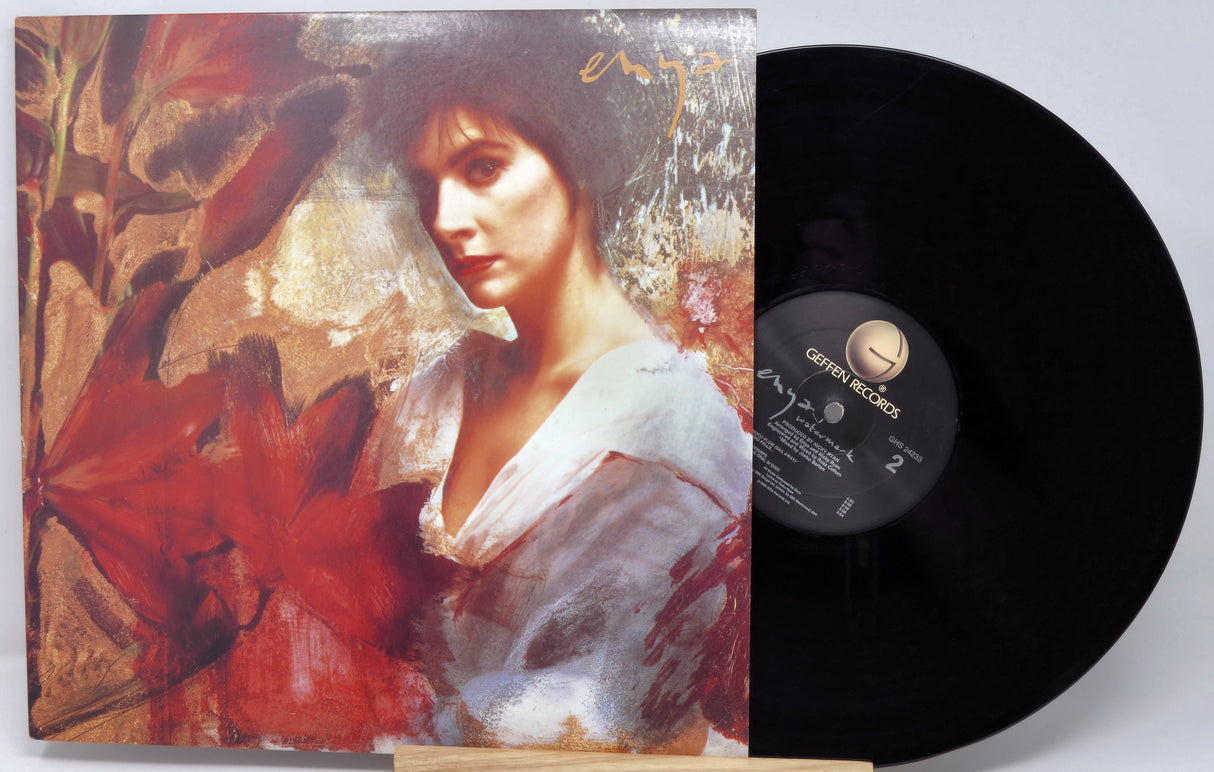 Vinyl record with a colorful cover featuring a woman's portrait and a red flower.