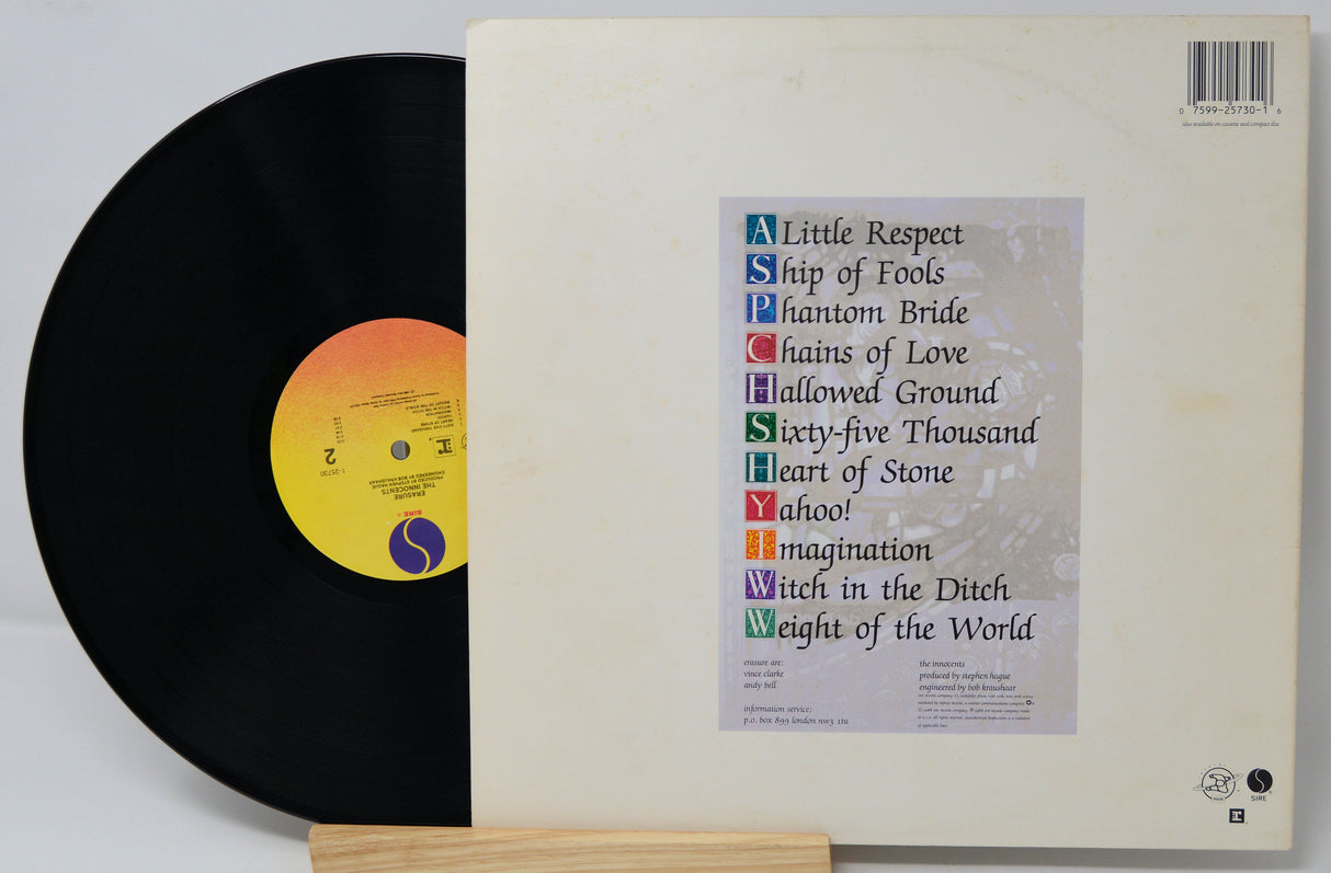 Vinyl record with cover displaying album tracklist on a white background
