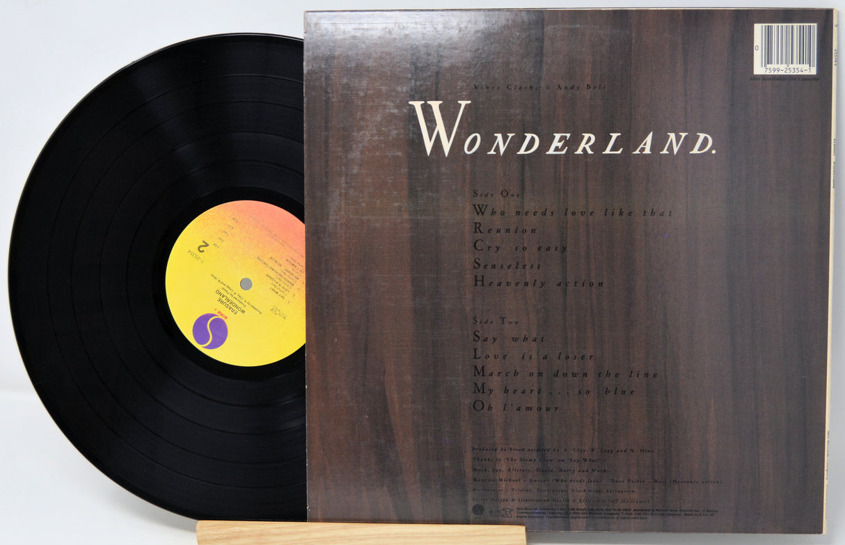 Vinyl record with a wooden stand displaying the cover titled 'Wonderland'.