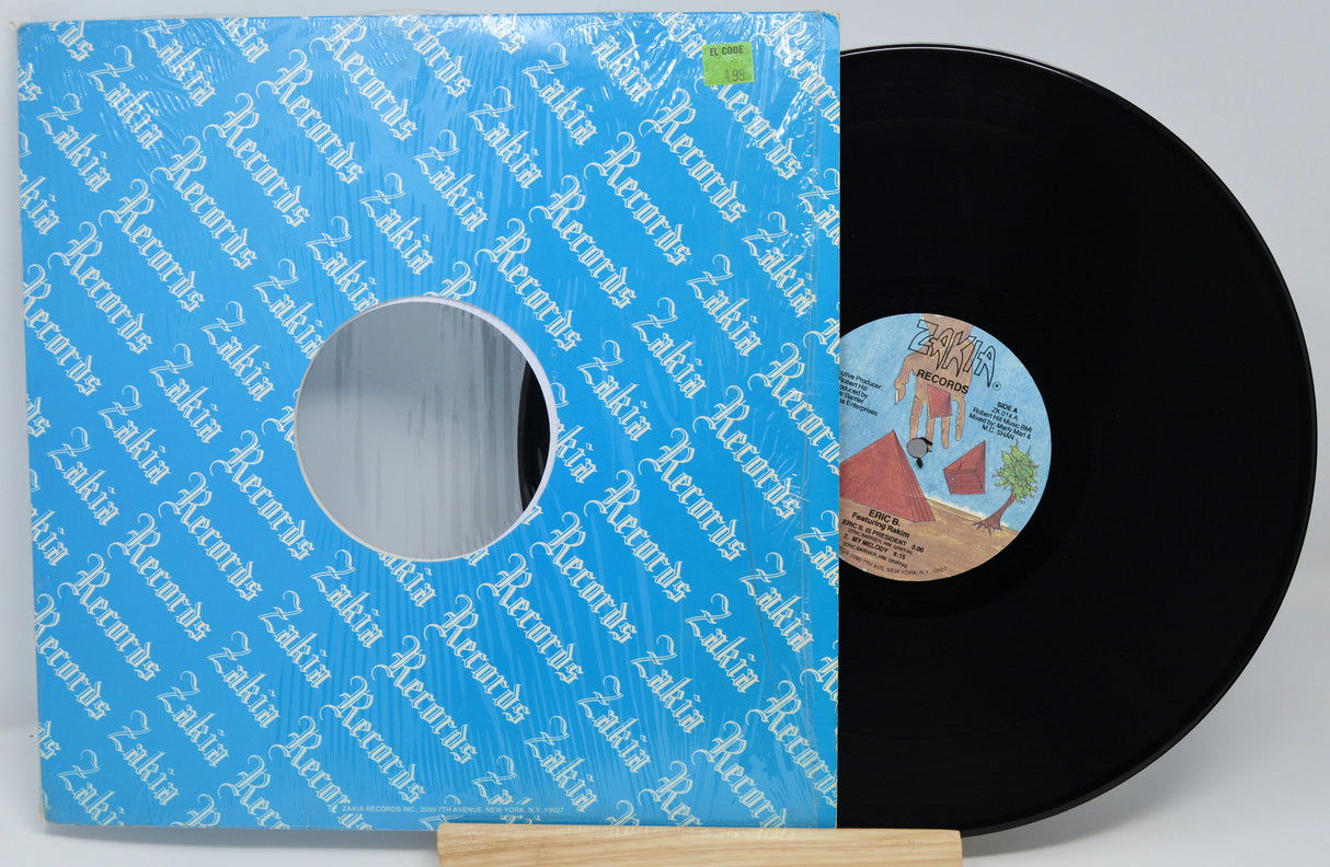 Vinyl record with a blue sleeve featuring text and a small label on a white background