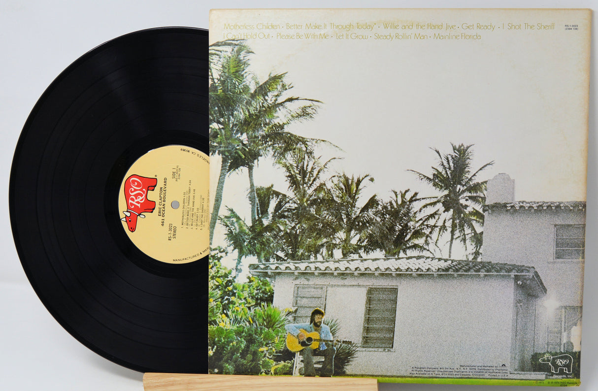 Vinyl record with a cover featuring a house and palm trees