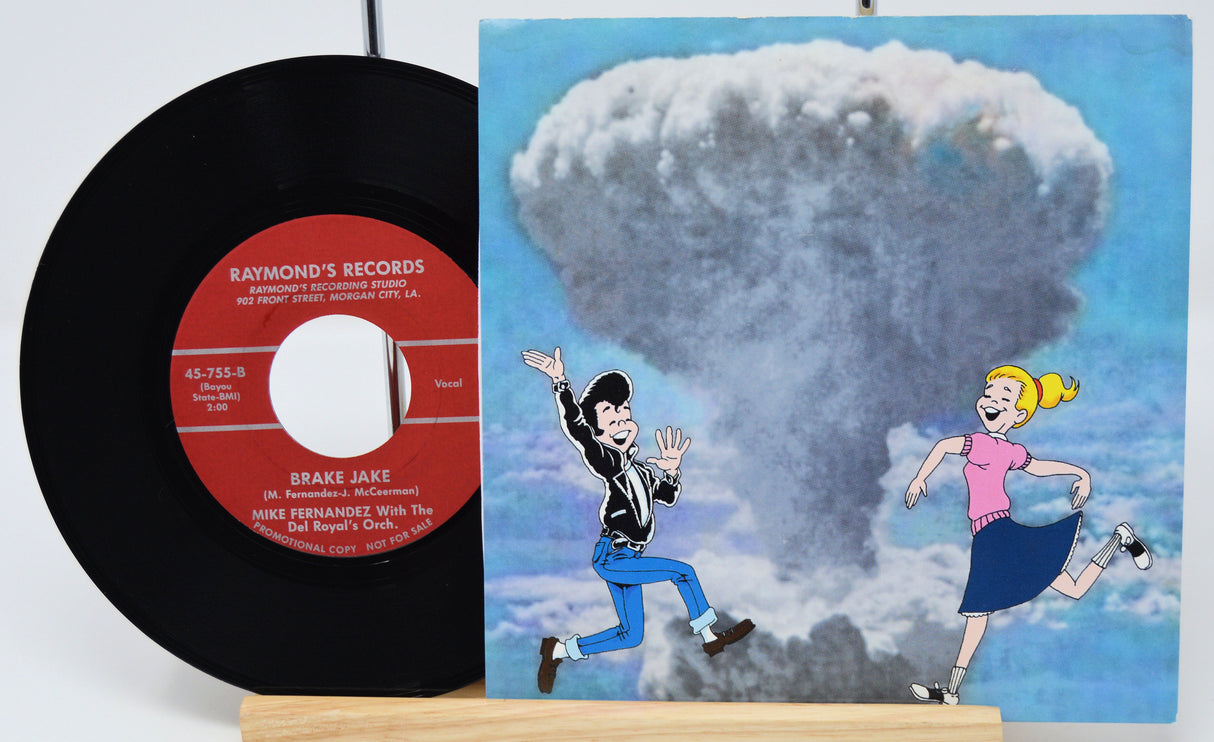 Vinyl record with a cartoon cover featuring two characters and an atomic bomb cloud.