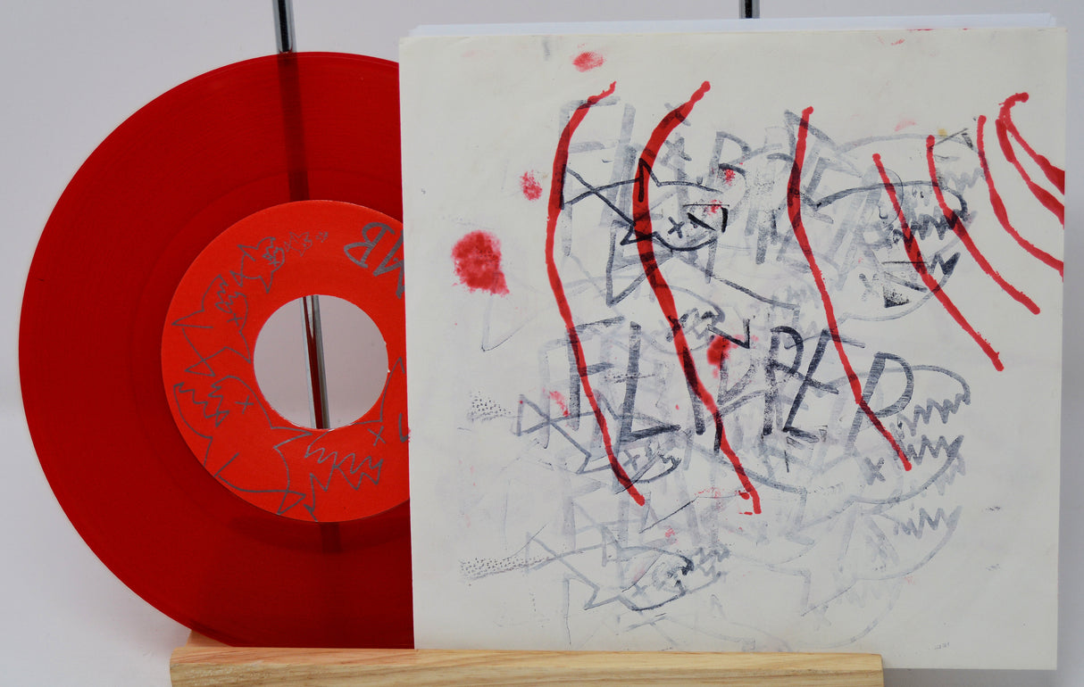 Red vinyl record with a white label featuring abstract art and text.