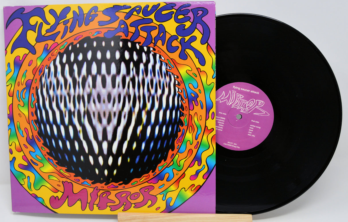 Vinyl record with colorful cover featuring 'Flying Saucer Attack' text