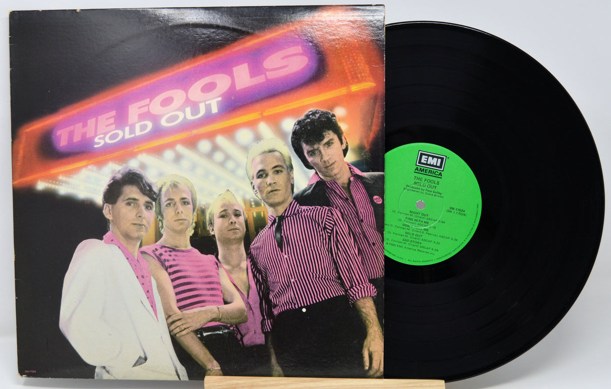Vinyl record with cover featuring a band and 'The Fools Sold Out' text.