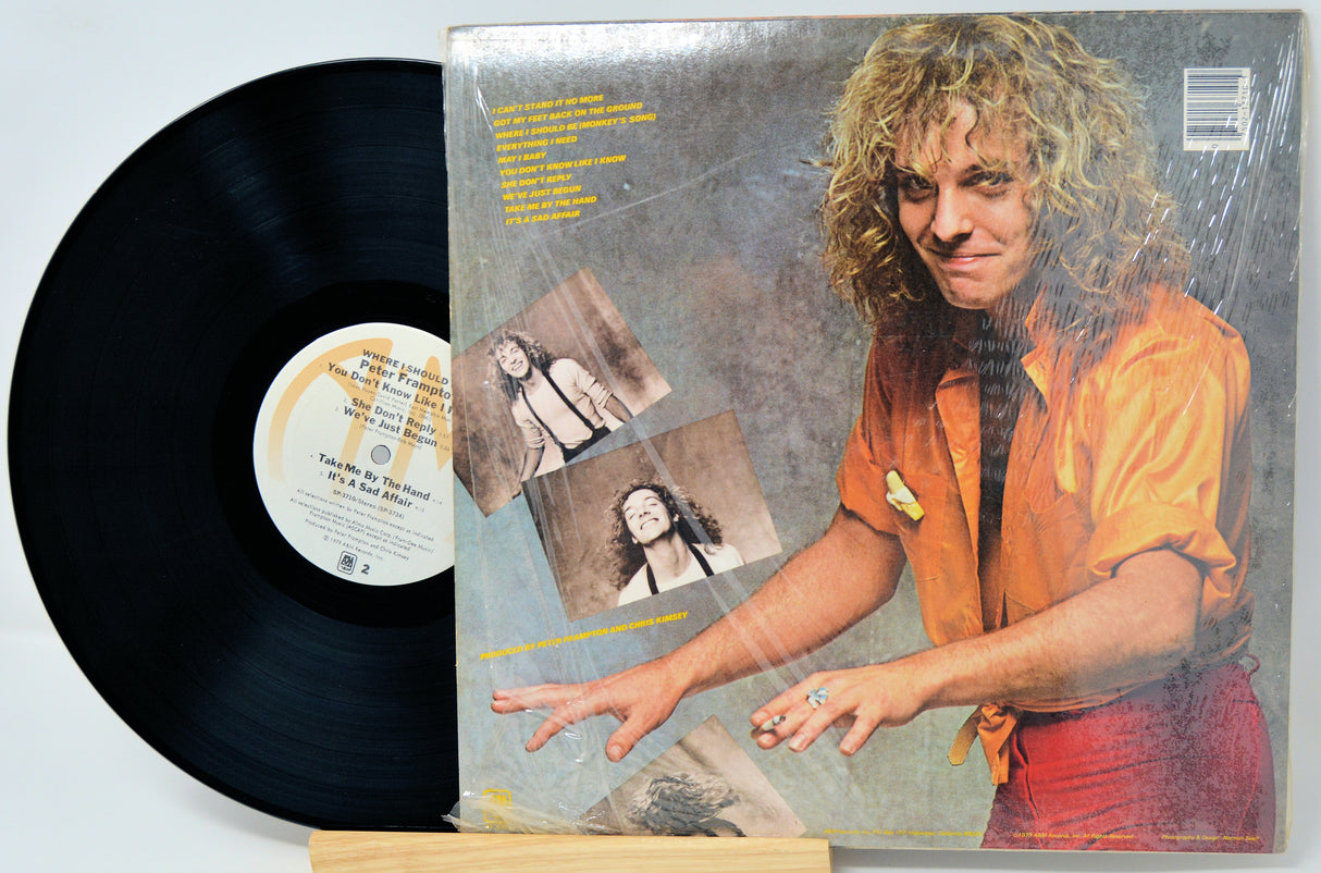 Vinyl record with a cover featuring a person and text on a light gray background