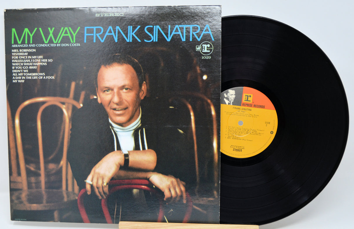 Vinyl record and cover of 'My Way' by Frank Sinatra on a light blue background