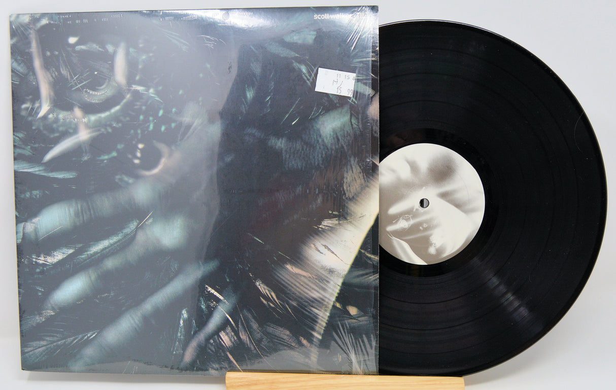 Scott Walker Tilt vinyl LP front cover with surreal artwork and record partially displayed