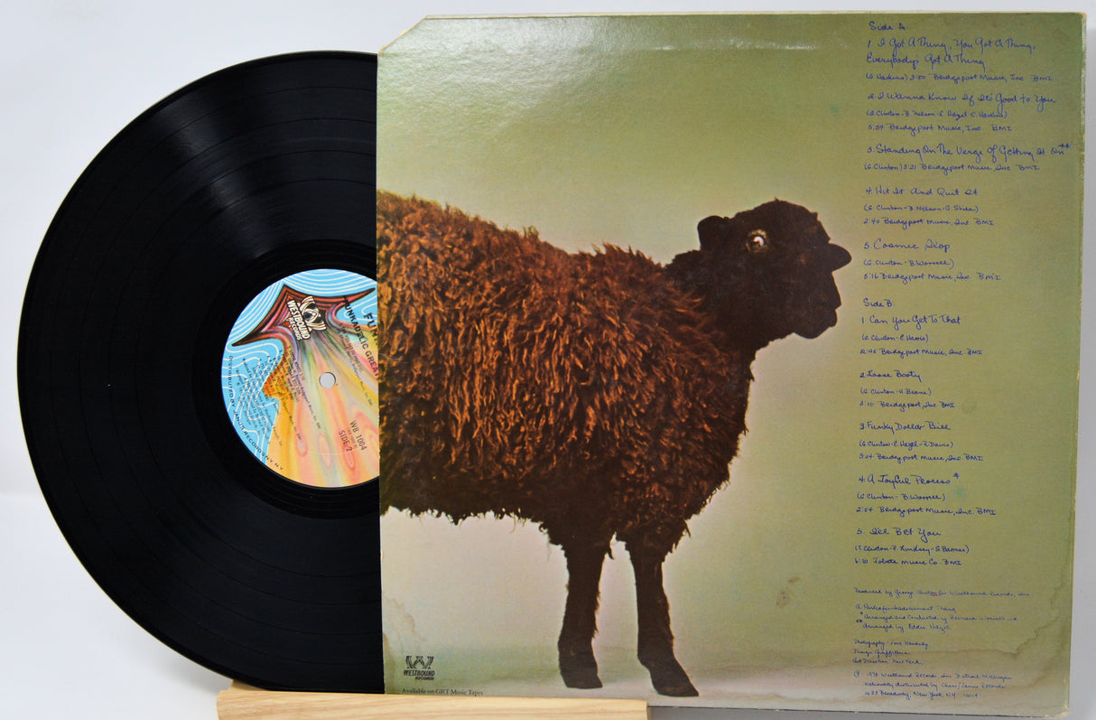 A vinyl record partially pulled from its sleeve, showing the black record on the left and the back cover of the album on the right with a brown sheep illustration and printed tracklist text.