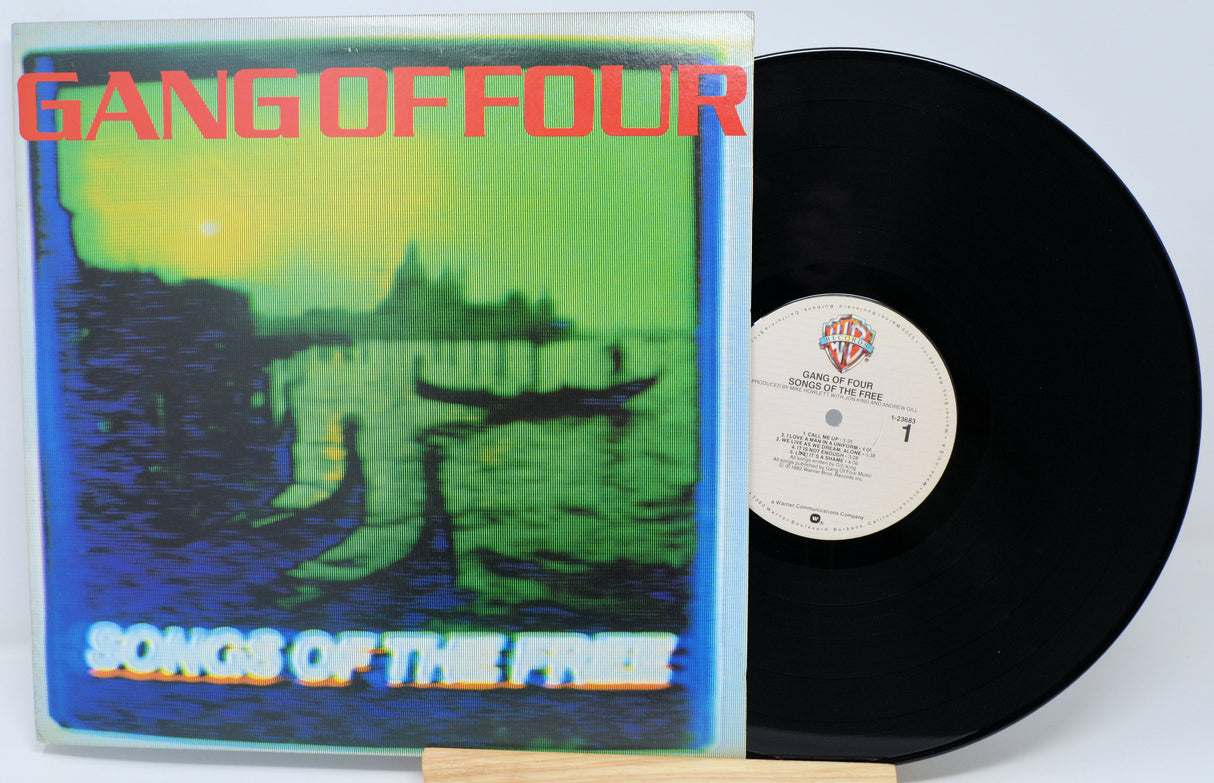 Vinyl record with 'Gang of Four' album cover showing a landscape and boat.