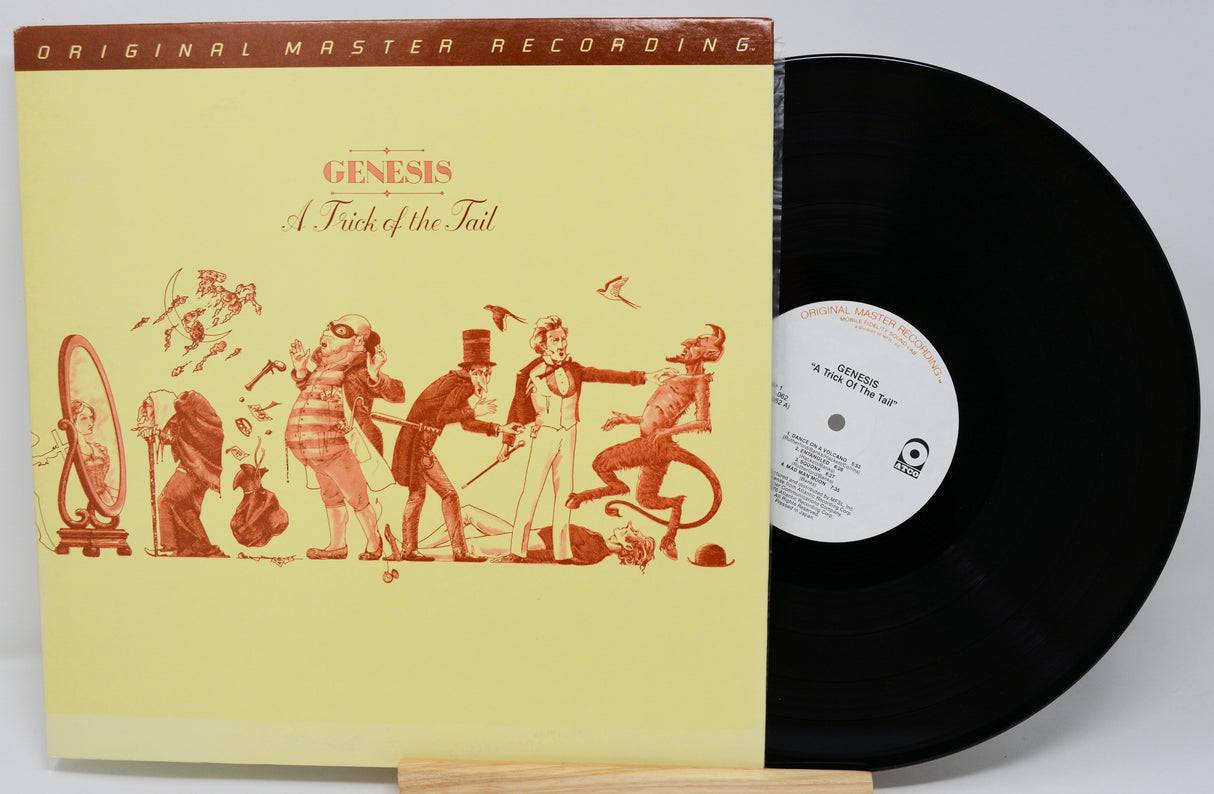Vinyl record with yellow cover featuring Genesis artwork and record label.