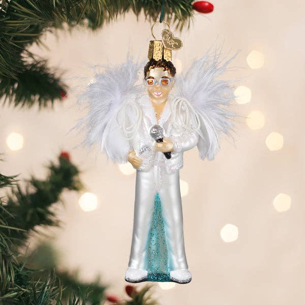 Glam rock singer ornament hanging on a Christmas tree with festive lights