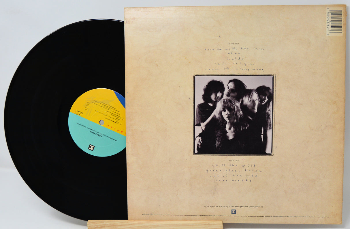 Vinyl record with a black cover featuring a band photo and a yellow label.
