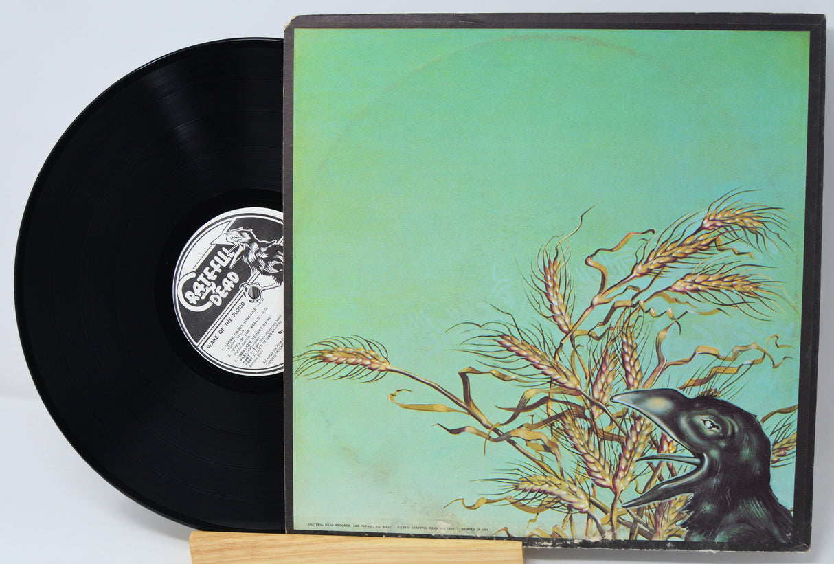 Vinyl record with a cover featuring a bird and wheat on a light blue background