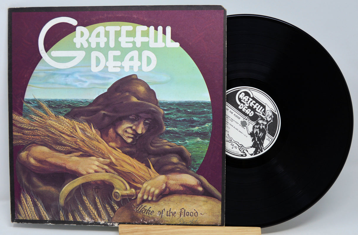 Vinyl record and cover of ' grateful dead' album on a white background