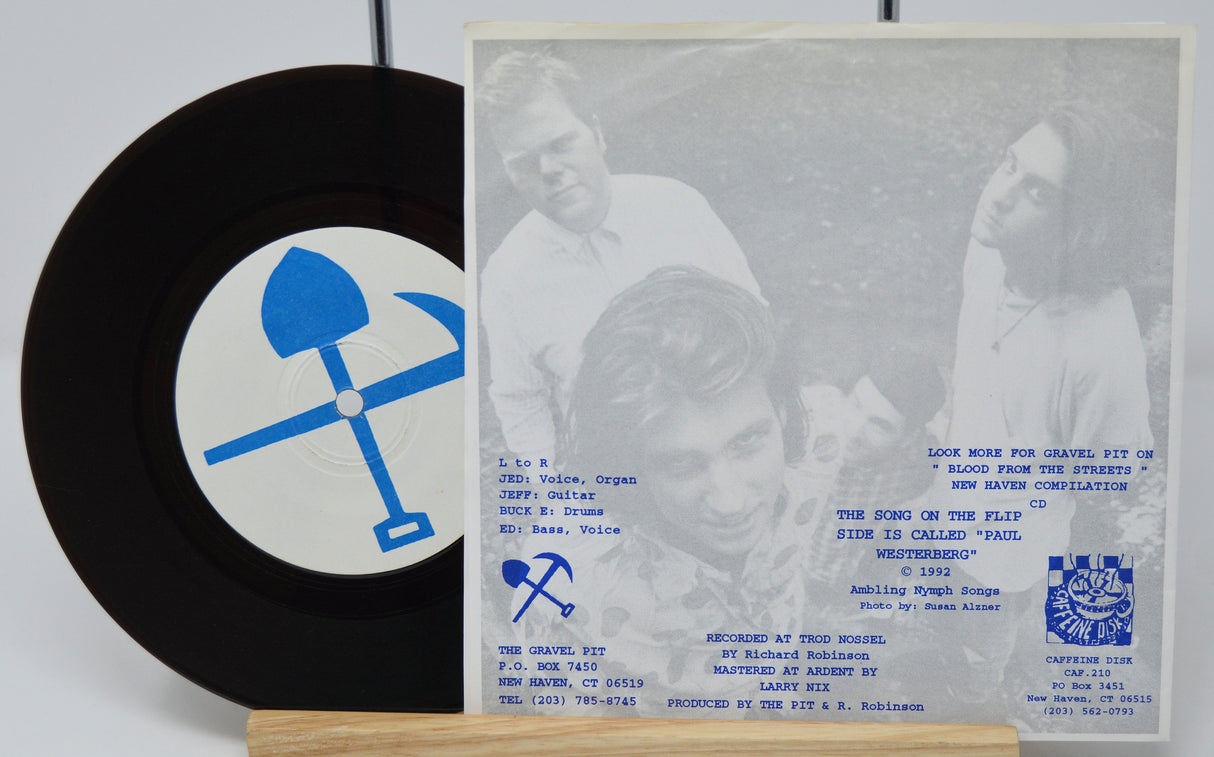 Vinyl record with blue logo and cover featuring text and images on a white background