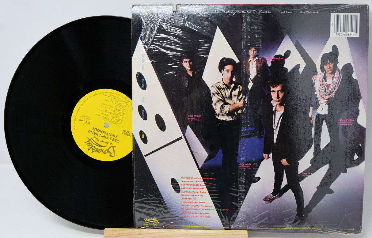 Vinyl record with a colorful cover featuring band members and dice design.