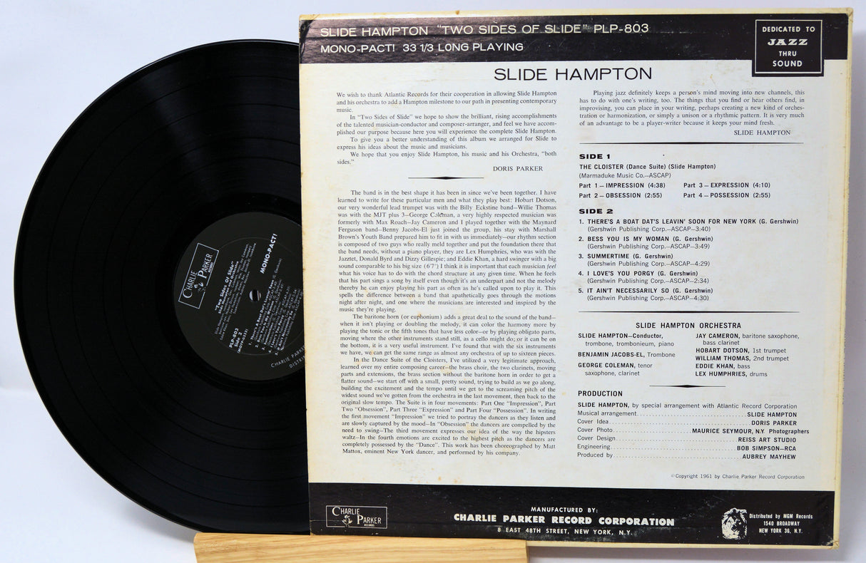 Vinyl record with a colorful cover featuring a person playing a trombone, on a white background.