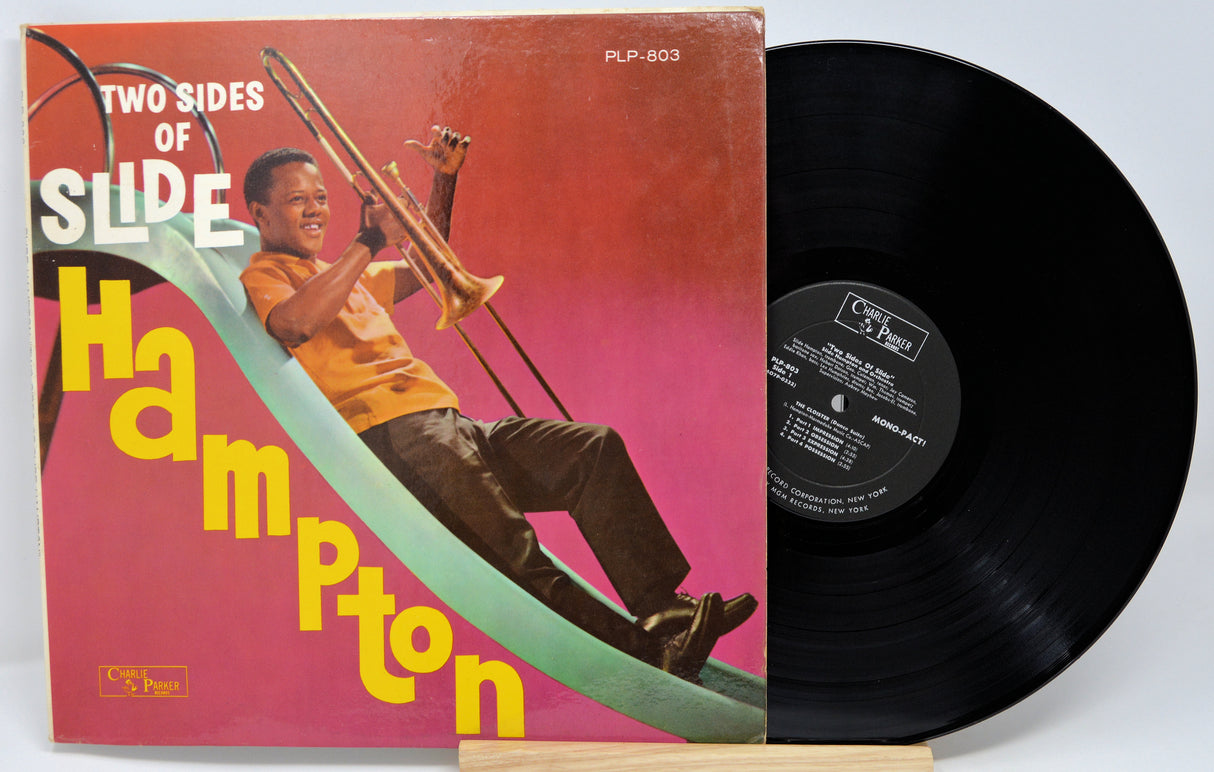Vinyl record with a colorful cover featuring a person playing a trombone, on a white background.