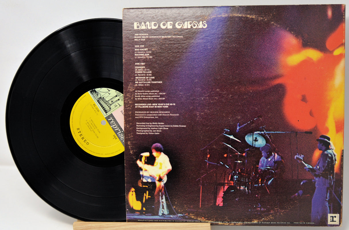 Vinyl record with a colorful album cover featuring musicians.