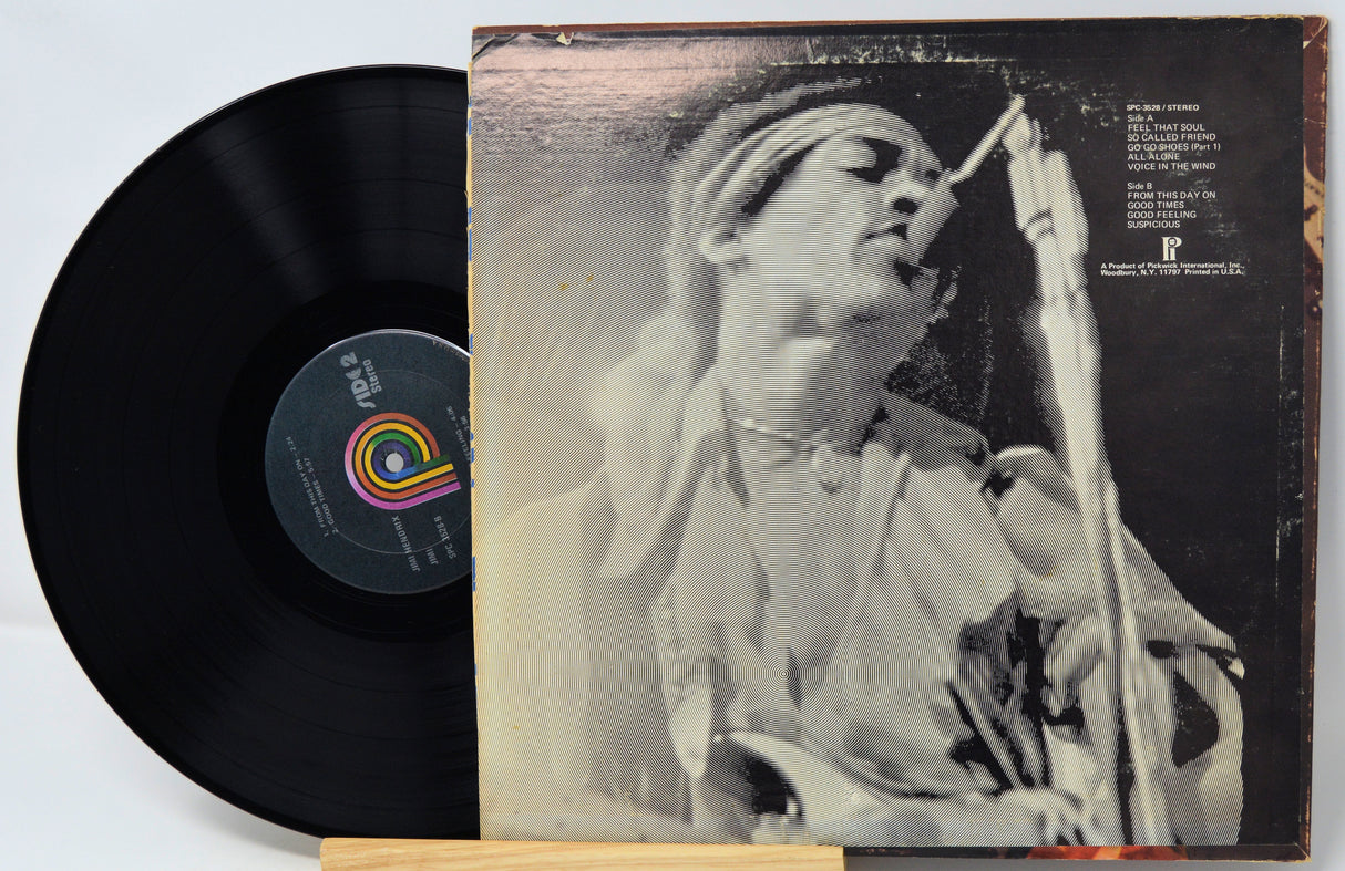 Vinyl record with a black cover featuring a person singing into a microphone.