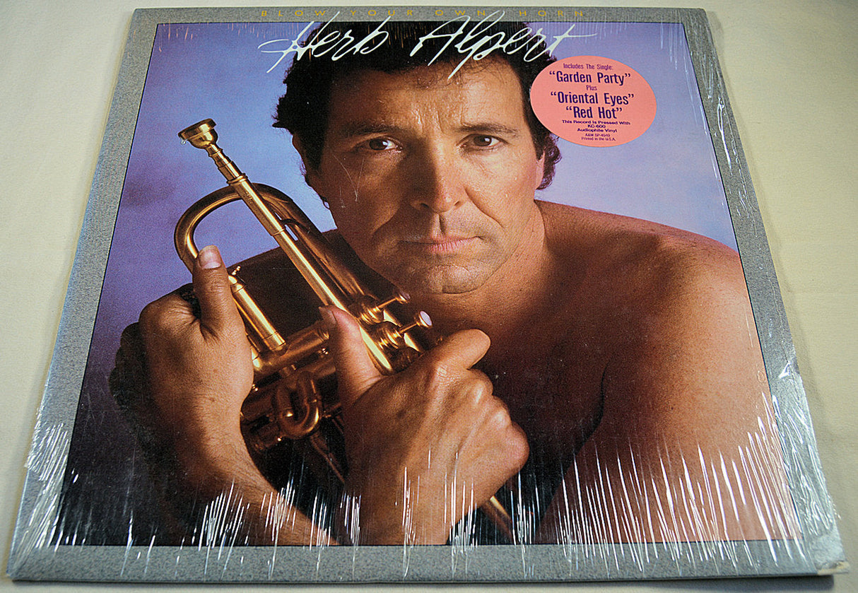 Front cover of Herb Alpert Blow Your Own Horn album featuring Herb Alpert holding trumpet