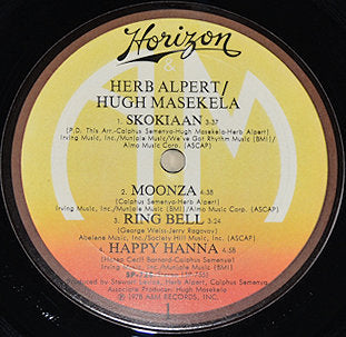 Close-up of the Herb Alpert and Hugh Masekela vinyl record label with tracklist on Horizon Records