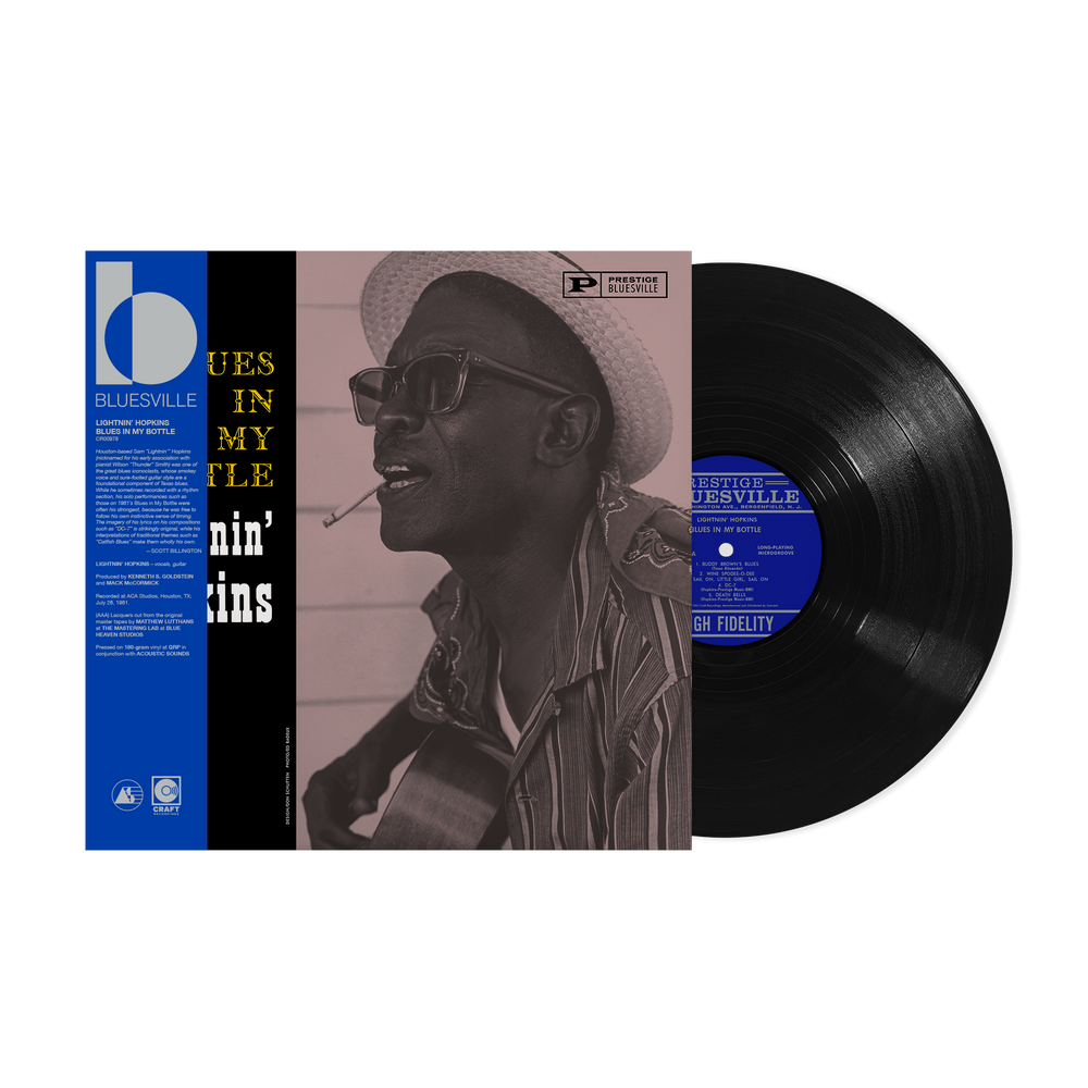 Vinyl record with a cover featuring a person wearing a hat and sunglasses, set against a white background.