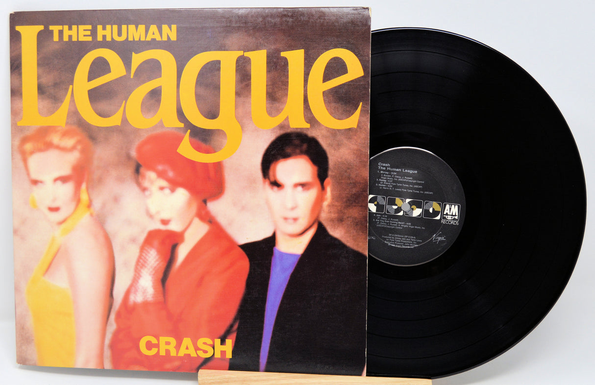 Vinyl record with 'The Human League' album cover featuring three people.