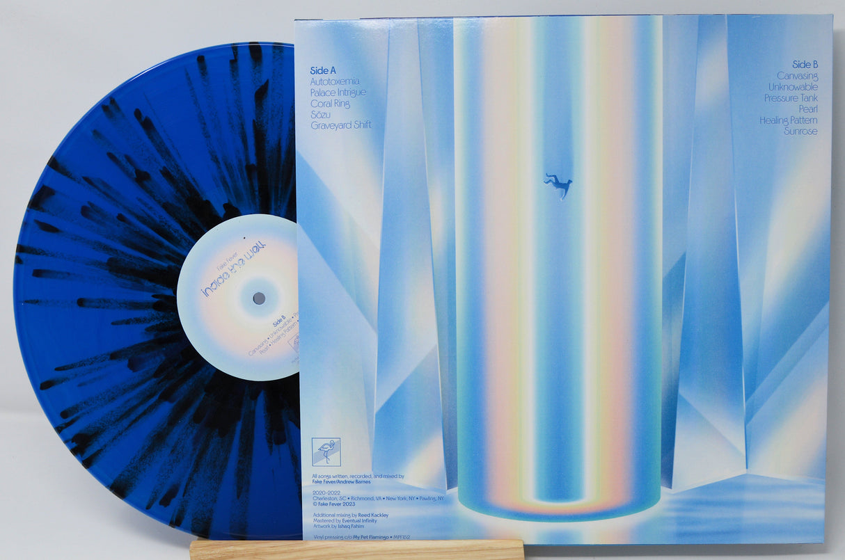 Back cover and blue splatter vinyl record of Fake Fever's Inside the Well with tracklist and abstract art