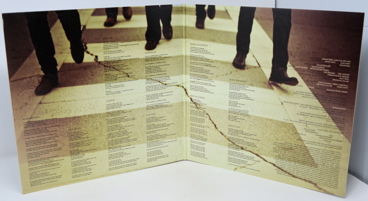 Open book with text and a visual of people walking on a cracked pavement.