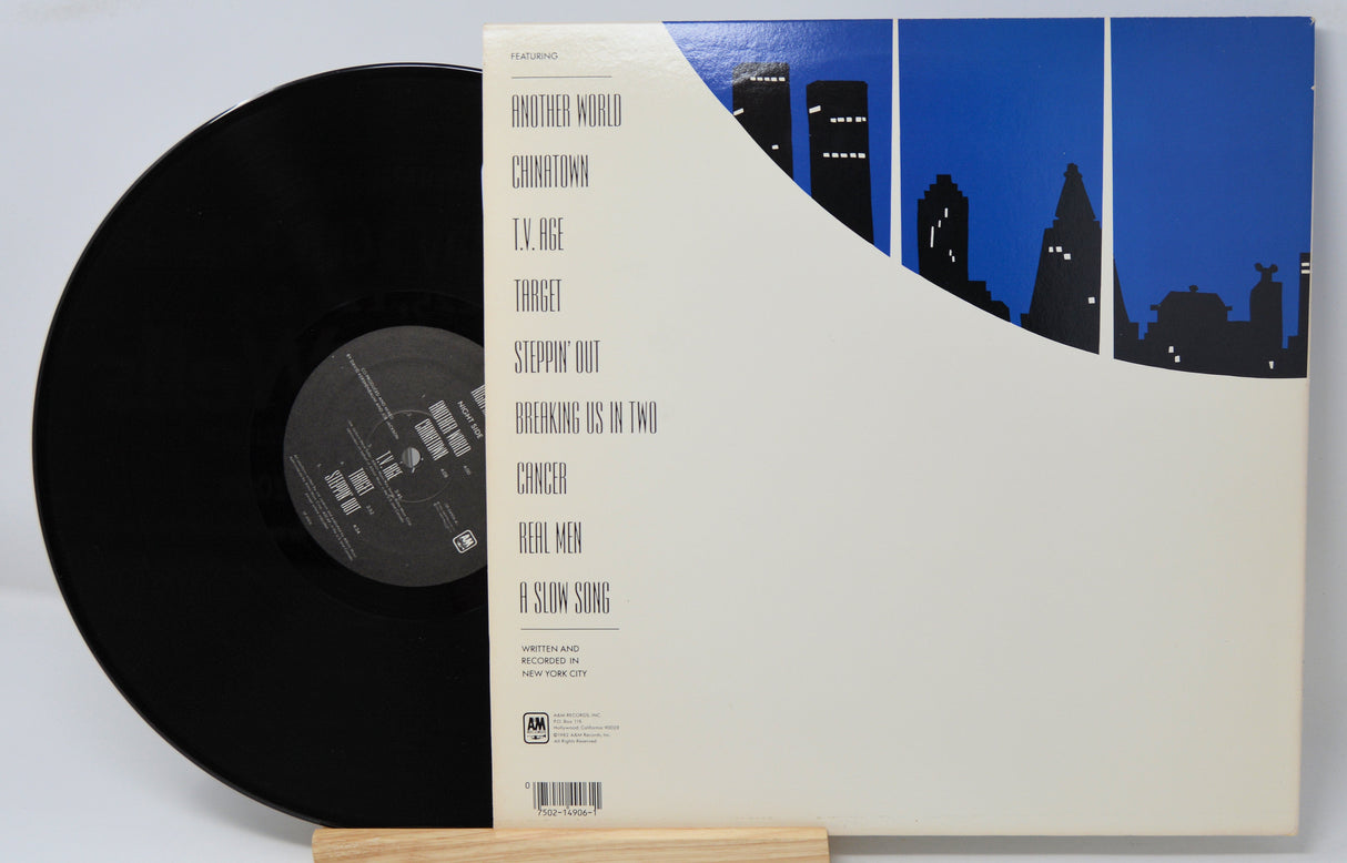 Vinyl record titled Night And Day by Joe Jackson showing the album and back cove with song titles in text.