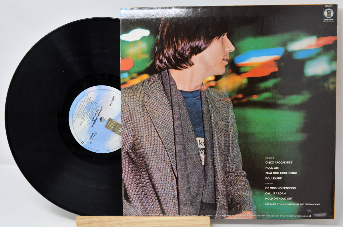 Vinyl record with a person on the cover against a colorful background