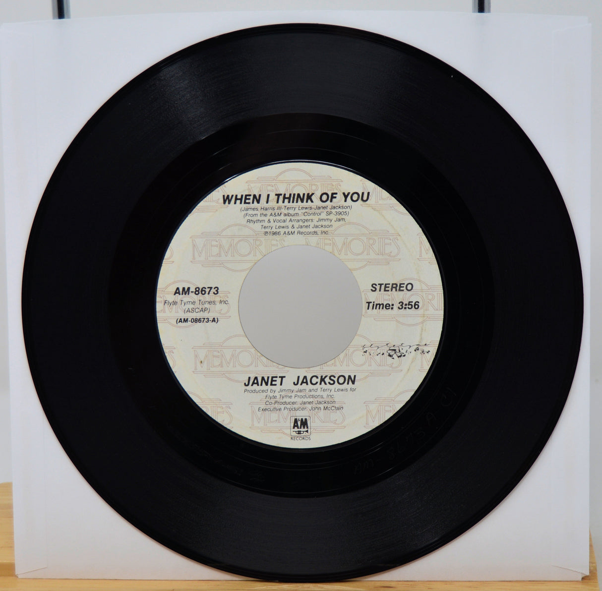 Vinyl record with 'When I Think of You' by Janet Jackson on a white background