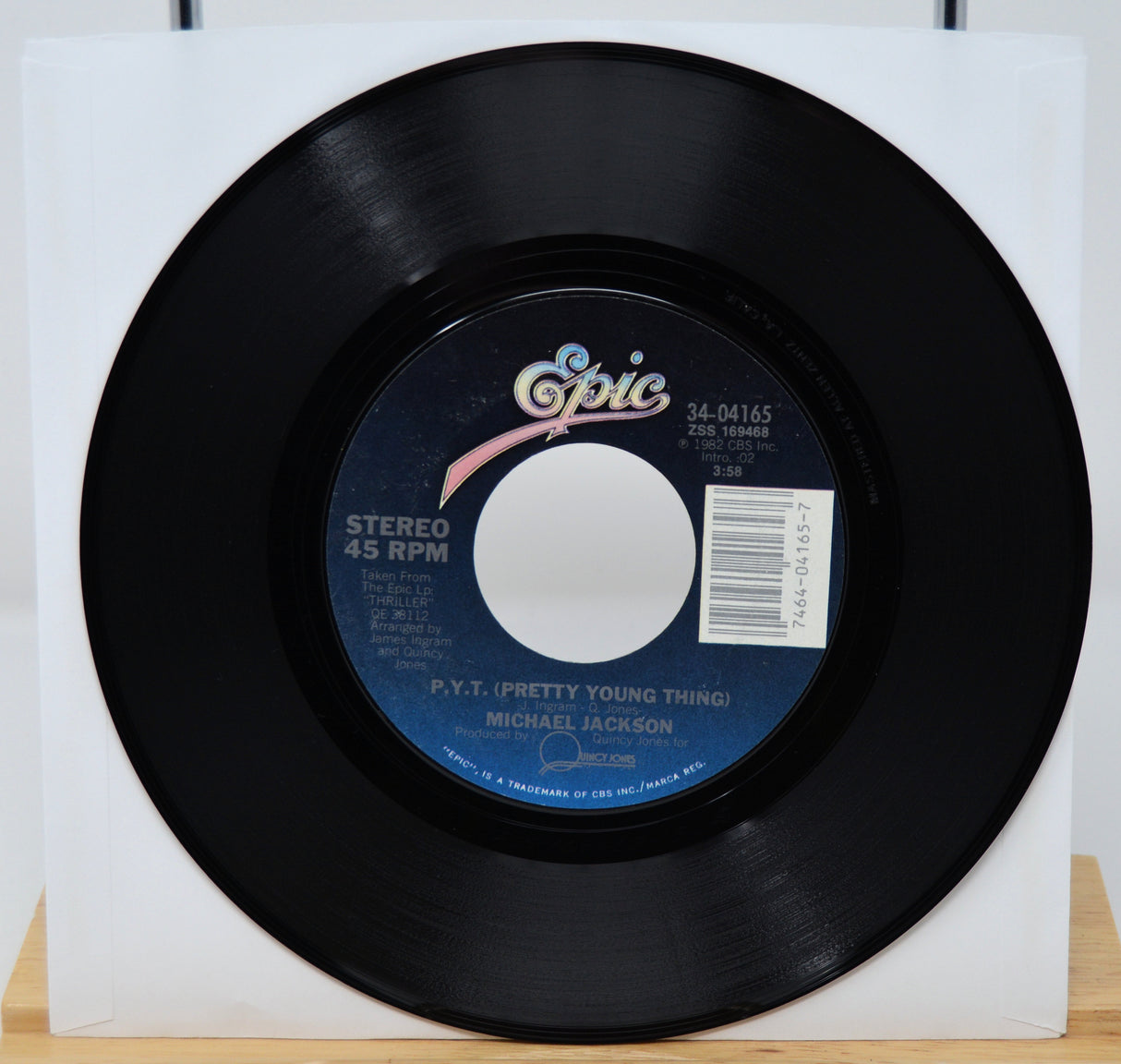Black vinyl record with 'Epic' label on a white background
