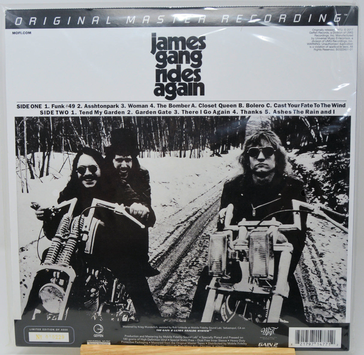 James Gang 'Again' 12-inch vinyl record LP cover, featuring a black and white photo of the band on motorcycles, with track listing and release details printed on the front.