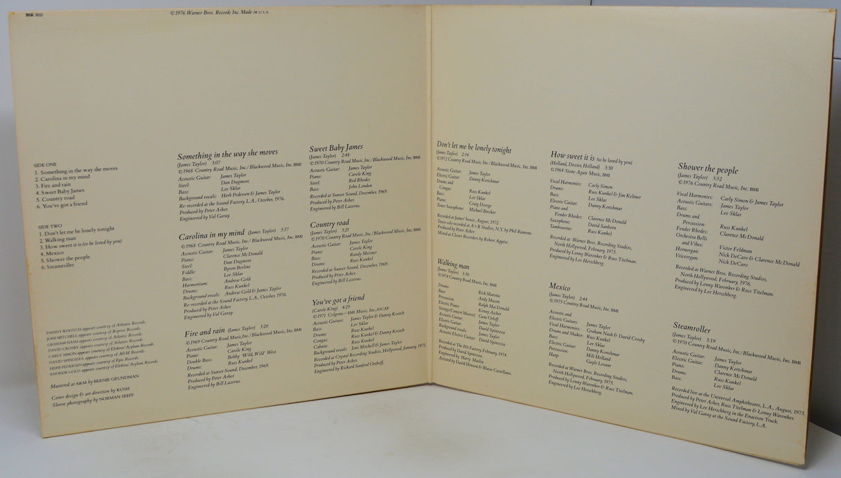 An open vintage songbook or printed booklet with cream-colored pages and black printed text, photographed against a light neutral background.