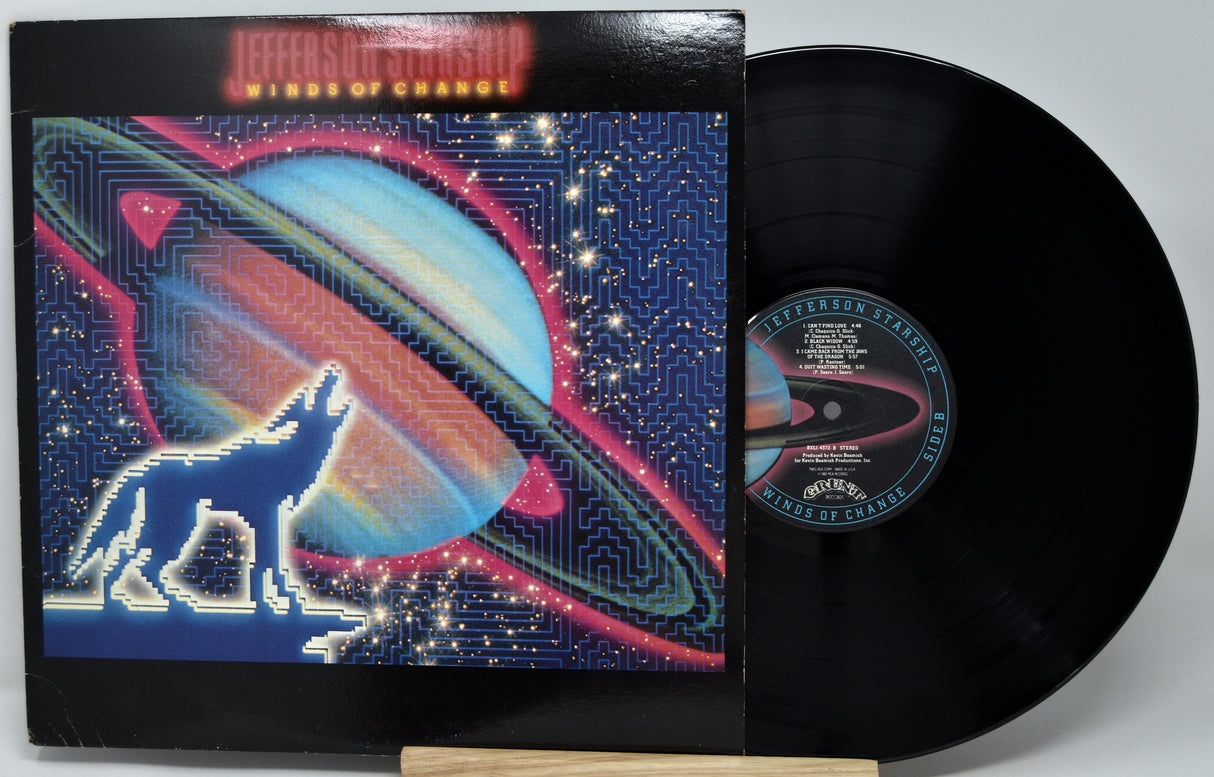 Vinyl record with a colorful cover featuring a wolf and planet design.