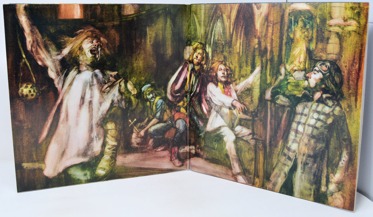 Illustrated book open to a page with characters in a fantasy setting