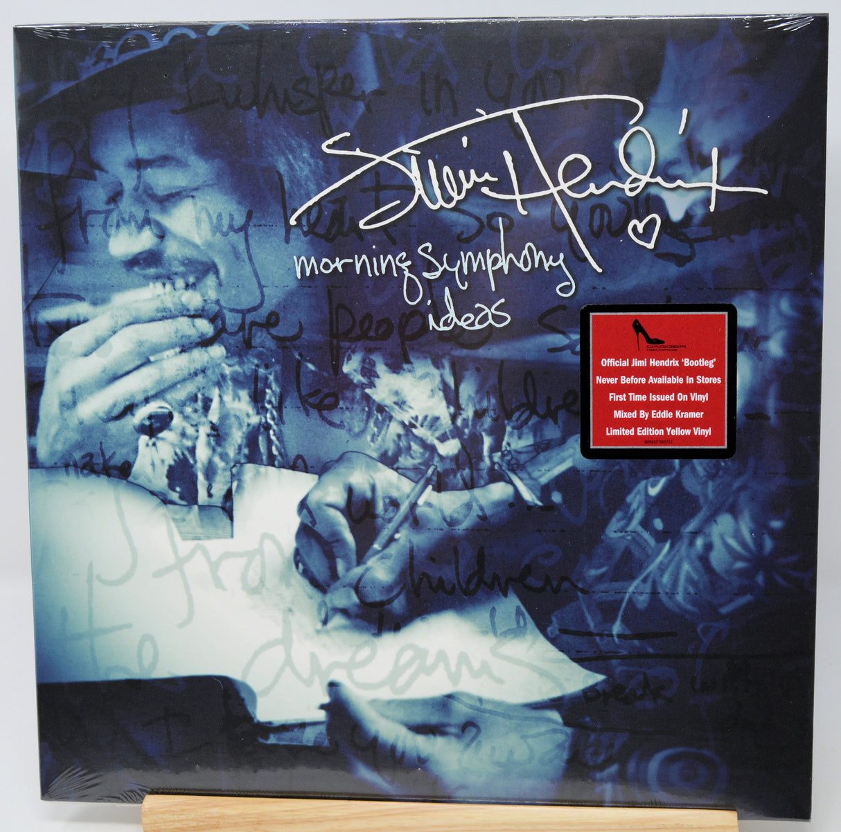 Signed Elvis Presley 'Morning Symphony Ideas' limited edition yellow vinyl LP album cover, autographed with a white marker signature and heart, displayed on a wooden stand.