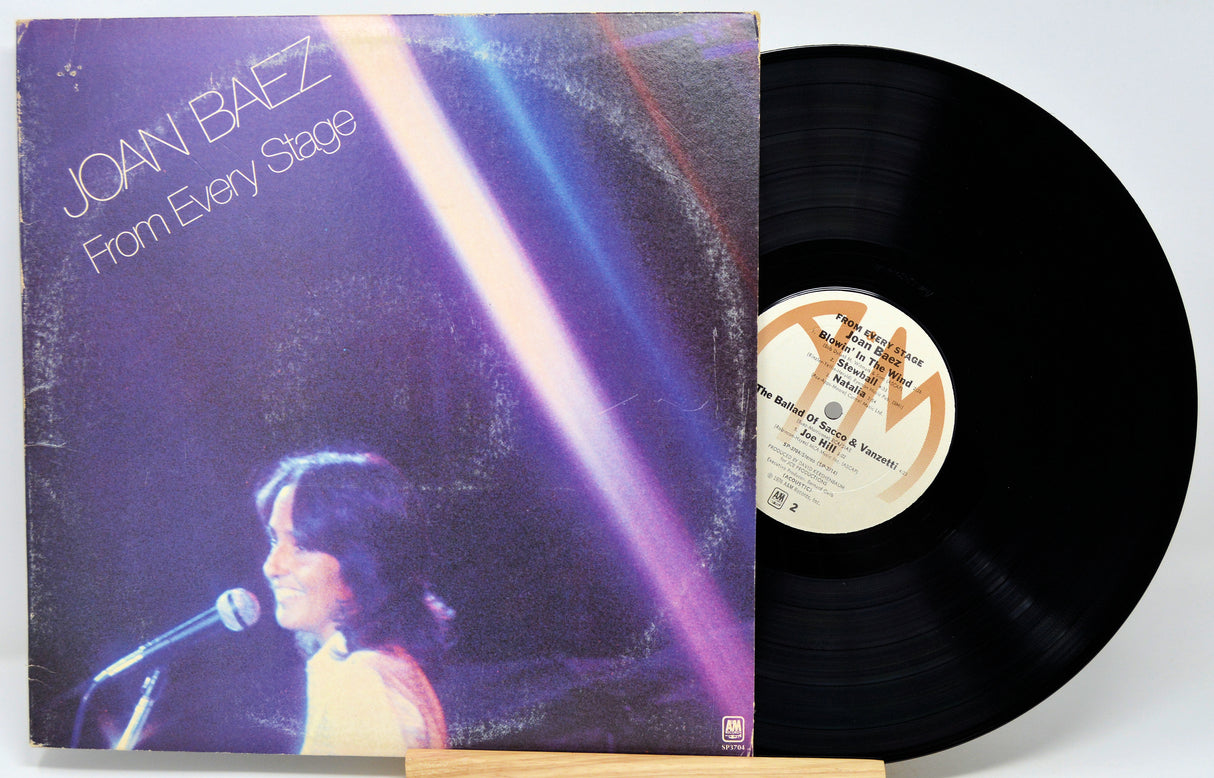 Joan Baez's 'From Every Stage' vinyl record LP, showing the illustrated album cover on the left and the black vinyl record partially pulled out on the right.
