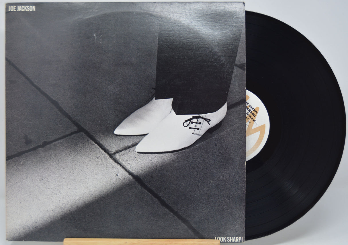 'Joe Jackson - Look Sharp' Vinyl record with a black and white photo of a person wearing shoes on the cover
