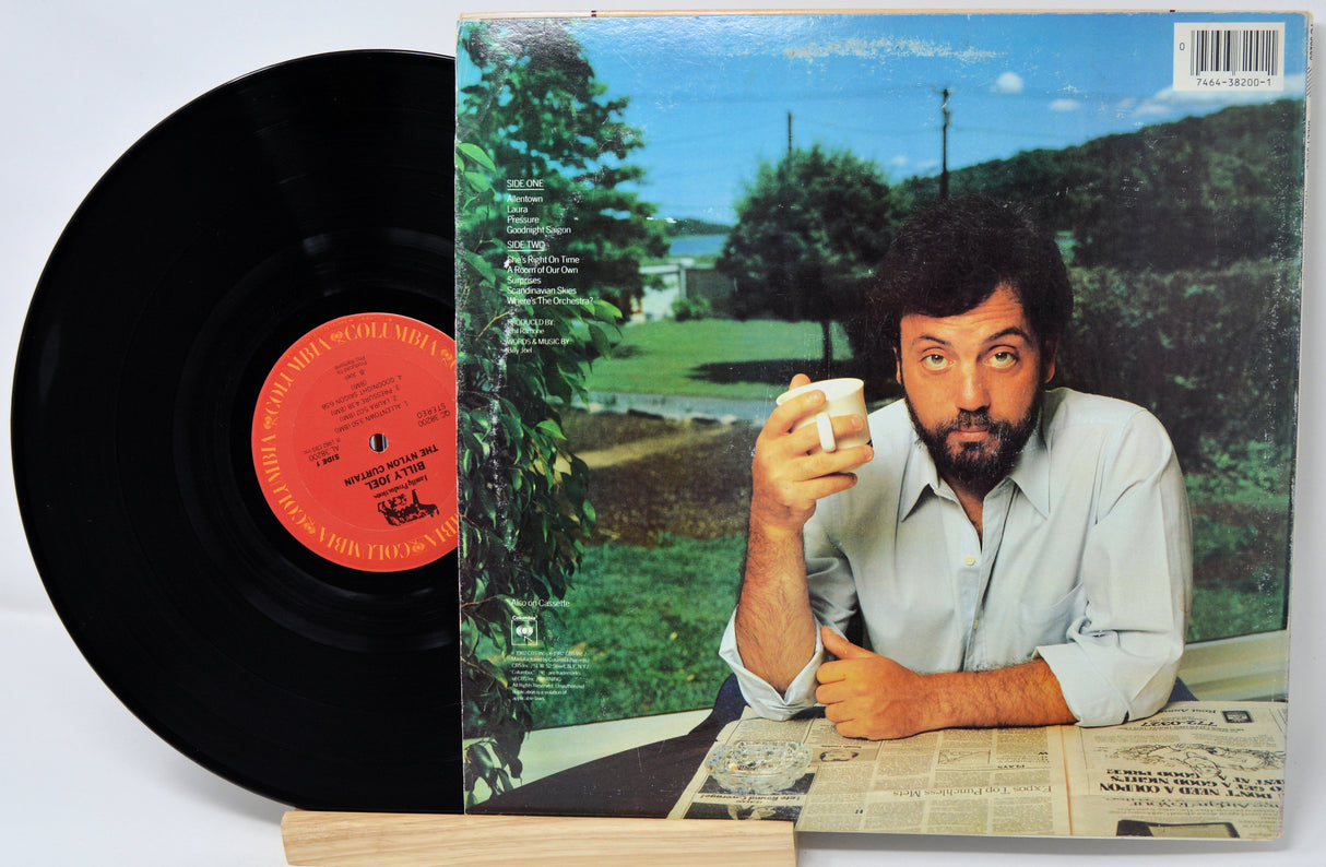 Vinyl record with a person on the cover, sitting outdoors.