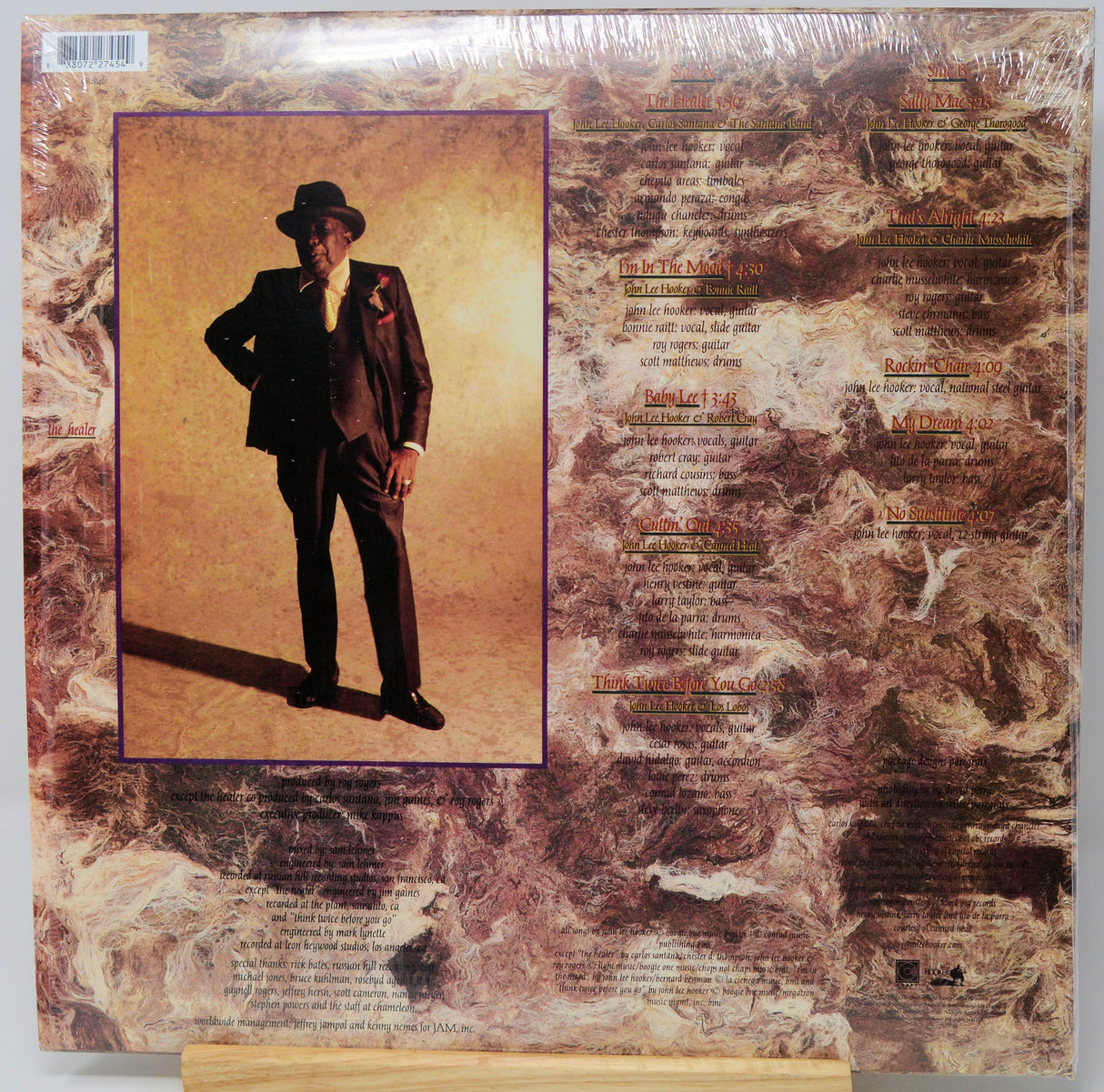 The back cover of a vinyl record album in shrink wrap, featuring a portrait of singer Sam Cooke in a dark suit and hat on the left, with tracklist text on the right over a textured brown and beige background.