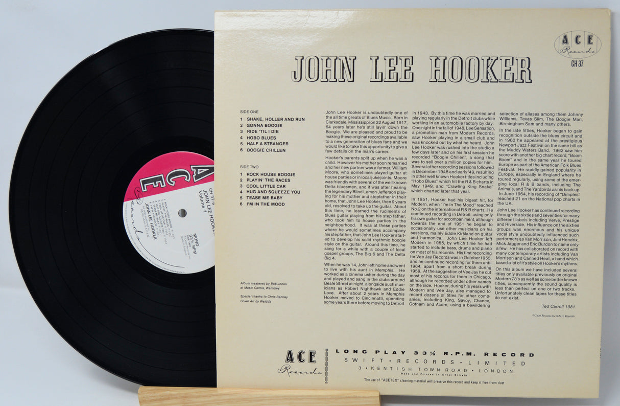Vinyl record with its cover displaying 'John Lee Hooker' on a light gray background