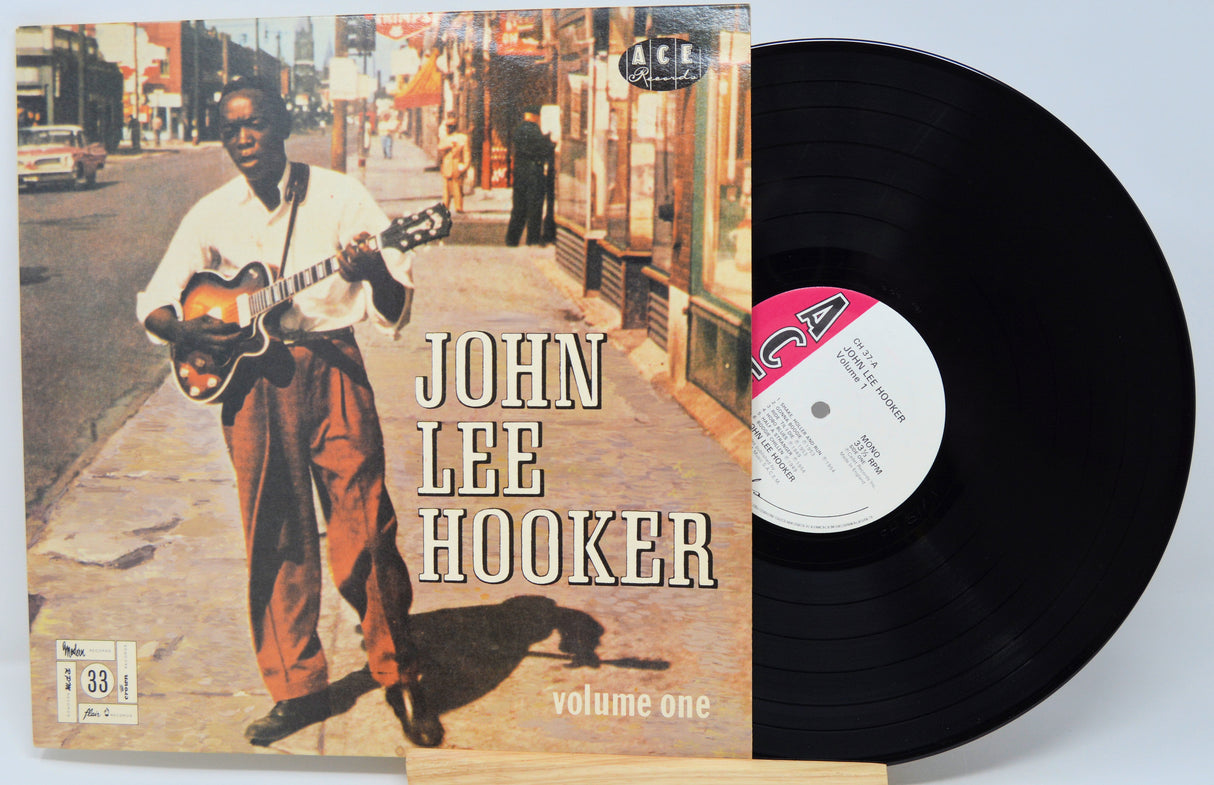 Vinyl record and cover featuring John Lee Hooker with a city street scene on the cover.