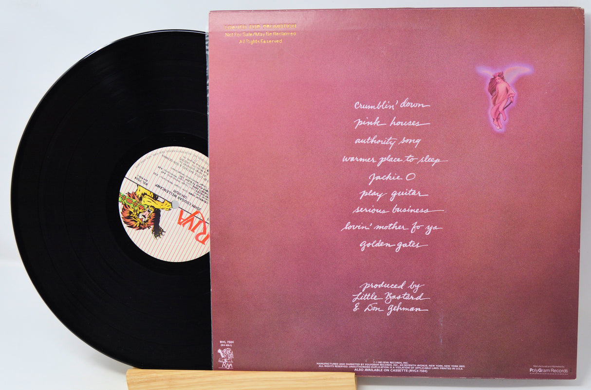 A vinyl record partially pulled from its sleeve, showing the black record and the back cover of the album. The sleeve has a pink-to-red gradient with white printed text and a small pink winged figure near the top right.